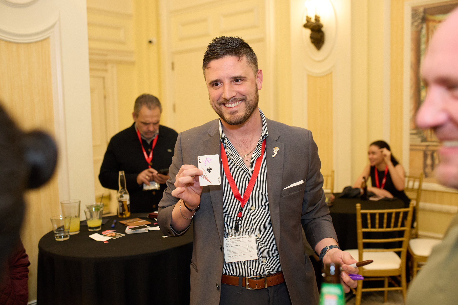 Milan revealing a signed card at a corporate event
